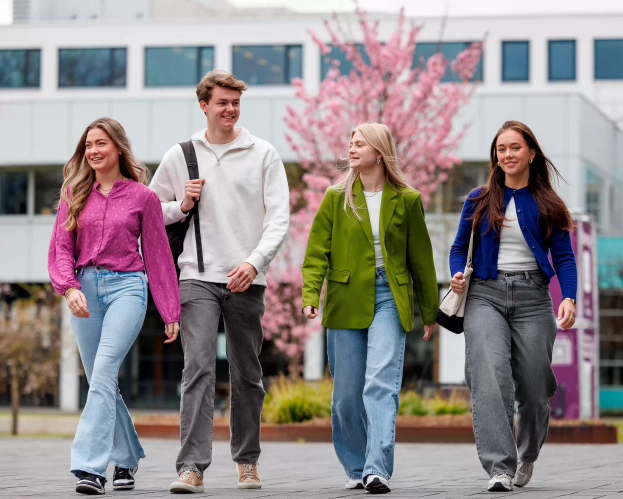 four students walking on the campus