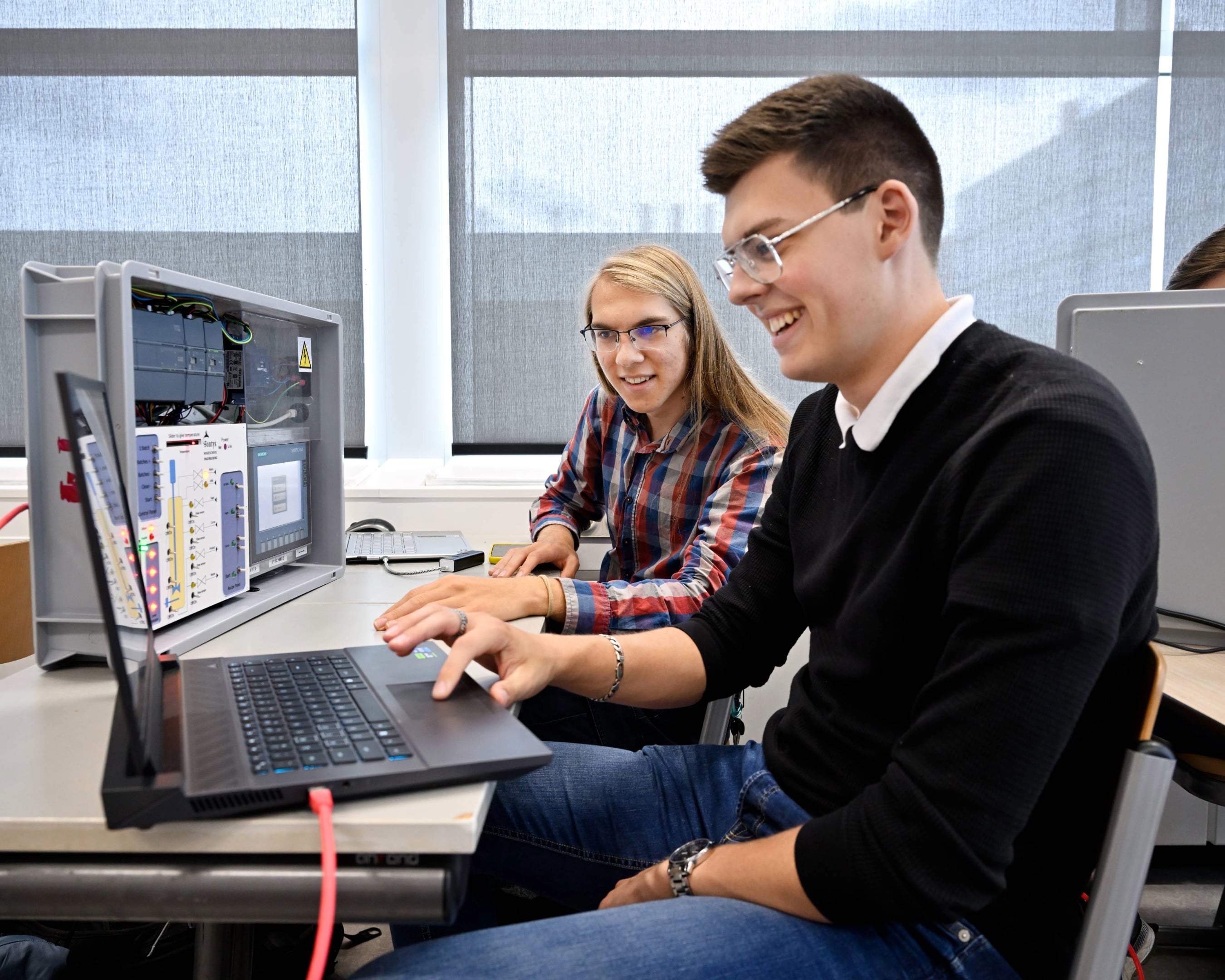 Studenten Mechatronica werken aan machine