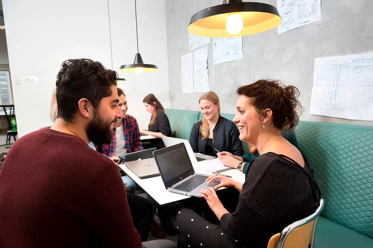 Group of students laughing and working