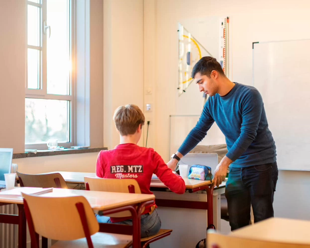 Docent geeft uitleg aan een student