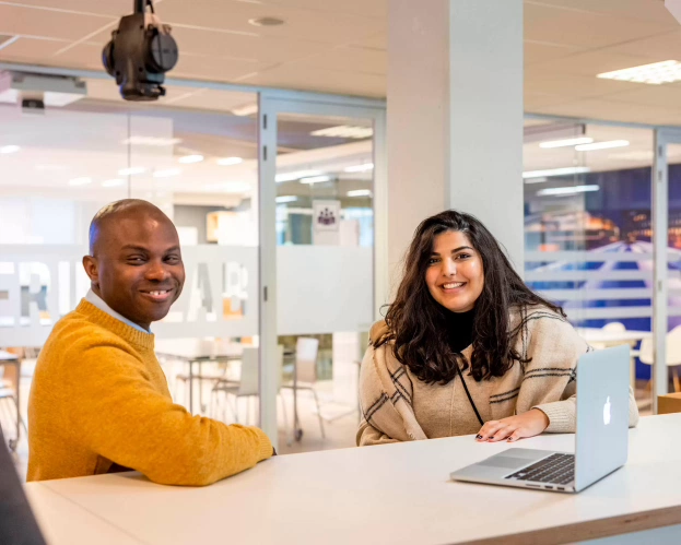 Two students behind a computer 