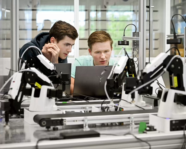 Mechatronics students working together on lab equipment